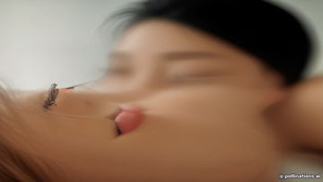 Lash artist meticulously applying a full set of lash extensions to a client in a professional salon