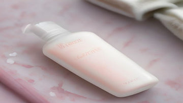 Oil-free micellar water and lash cleansing tools on a pastel background
